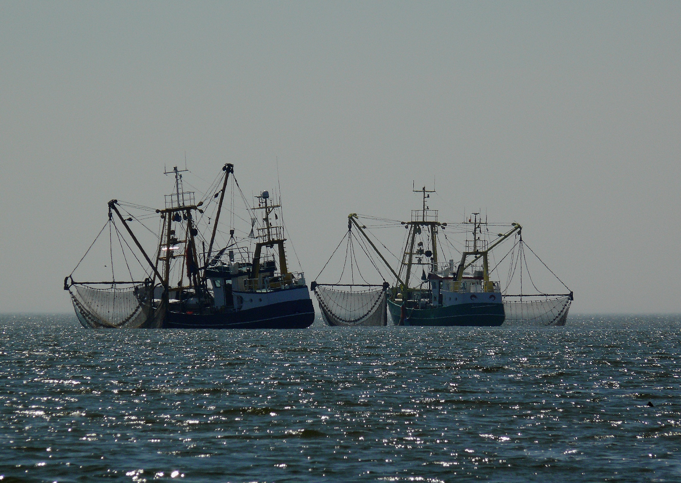 Zwei Fischkutter versenken Schleppnetze ins Meer. © Pixabay / Moritz 320